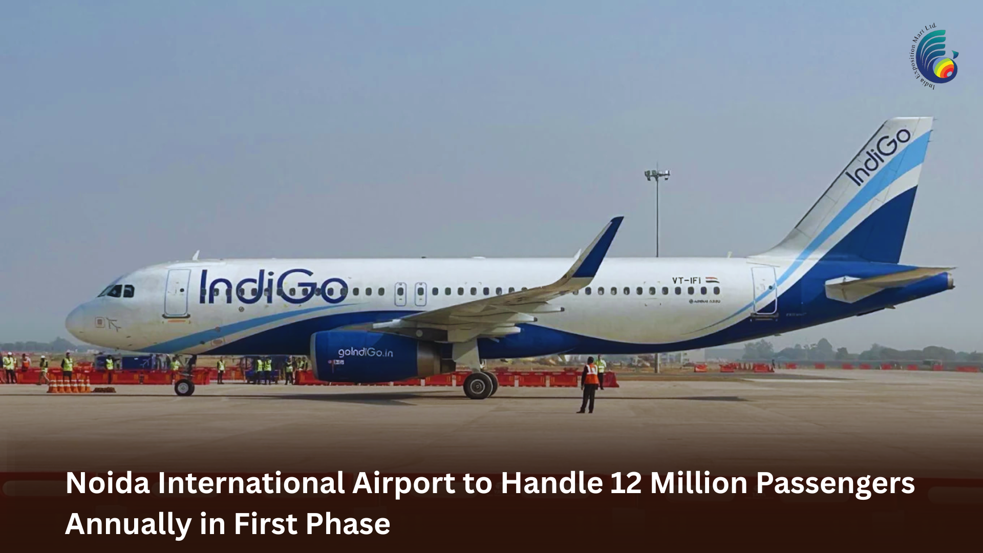 An IndiGo aircraft on the runway at Noida International Airport with staff visible nearby.